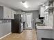 Well-lit kitchen featuring stainless steel appliances, gray cabinets, and easy access to a back door at 410 Invector Ct, Locust Grove, GA 30248