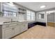 Well-lit kitchen featuring stainless steel sink, gray cabinets, and tiled floors at 410 Invector Ct, Locust Grove, GA 30248