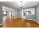 An open-concept living room showcasing hardwood floors, neutral walls, and seamless transitions to other rooms at 410 Invector Ct, Locust Grove, GA 30248