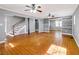 Open living area featuring hardwood floors, a staircase, and stylish furniture at 410 Invector Ct, Locust Grove, GA 30248