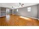 Spacious living room featuring hardwood floors, ceiling fans and a rustic wood accent wall at 410 Invector Ct, Locust Grove, GA 30248
