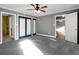 Main bedroom with carpeted floors, ensuite bath access, and spacious closet with dark trim at 410 Invector Ct, Locust Grove, GA 30248