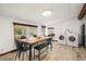 Dining room with a long wood table, black chairs, bench and laundry area at 996 Moreland Se Ave, Atlanta, GA 30316