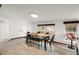 Dining room with a long wood table, black chairs, bench and two windows at 996 Moreland Se Ave, Atlanta, GA 30316