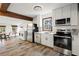 Modern kitchen with white cabinetry, stainless steel appliances, and a dining area at 996 Moreland Se Ave, Atlanta, GA 30316