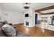 Open-concept living area with hardwood floors, fireplace, and seamless access to the kitchen at 996 Moreland Se Ave, Atlanta, GA 30316
