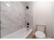 Modern bathroom showcasing new white tile shower and a toilet at 1351 Mckendree Park Ct, Lawrenceville, GA 30043