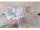 Bathroom with soaking tub, double windows, and marble tile shower at 1351 Mckendree Park Ct, Lawrenceville, GA 30043