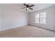Neutral bedroom with carpet, ceiling fan and window overlooking trees at 1351 Mckendree Park Ct, Lawrenceville, GA 30043