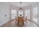 Cozy breakfast nook with three windows, a modern light fixture, and a door to the patio at 1351 Mckendree Park Ct, Lawrenceville, GA 30043