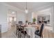 Elegant dining room with wainscoting, hardwood floors, and a view of the kitchen at 1351 Mckendree Park Ct, Lawrenceville, GA 30043