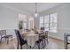 Formal dining room features elegant lighting, hardwood floors, and a large window at 1351 Mckendree Park Ct, Lawrenceville, GA 30043