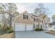 Charming two-story home with neutral stucco, black shutters, white trim, and a spacious two-car garage at 1351 Mckendree Park Ct, Lawrenceville, GA 30043