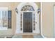 Elegant front entrance with arched transom, sidelights, and a welcoming 'Welcome' mat at 1351 Mckendree Park Ct, Lawrenceville, GA 30043