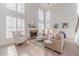 The light-filled living room features a stone fireplace, many windows, and comfortable seating at 1351 Mckendree Park Ct, Lawrenceville, GA 30043