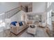 Spacious open-concept living area features a stone fireplace, high ceilings, and stairs to the second level at 1351 Mckendree Park Ct, Lawrenceville, GA 30043