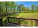 Large backyard with lush greenery, shed and wood fence at 5570 Rolling Oaks Dr, Cumming, GA 30040