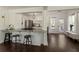 Modern kitchen featuring an open layout, stainless steel appliances, granite countertops, and hardwood floors at 5570 Rolling Oaks Dr, Cumming, GA 30040