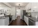 Modern kitchen with stainless steel appliances, granite countertops, white cabinets, and subway tile backsplash at 5570 Rolling Oaks Dr, Cumming, GA 30040