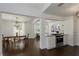 Open-concept kitchen and dining room with stainless steel appliances and dark wood floors at 5570 Rolling Oaks Dr, Cumming, GA 30040