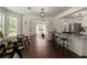 Open concept living space features hardwood floors, seamless integration of living room, dining area, and kitchen at 5570 Rolling Oaks Dr, Cumming, GA 30040