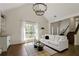 Bright and airy living room features a fireplace, a large window, and dark hardwood floors at 5570 Rolling Oaks Dr, Cumming, GA 30040