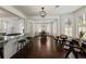 Open floor plan seamlessly connects the living room with the kitchen and dining areas, with dark hardwood floors at 5570 Rolling Oaks Dr, Cumming, GA 30040