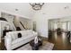 Bright and airy living room with dark hardwood floors that connect to the dining area and staircase at 5570 Rolling Oaks Dr, Cumming, GA 30040
