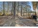 A grassy backyard with a wooden deck providing a serene outdoor retreat at 6615 Buckhurst Trl, Atlanta, GA 30349