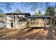Rear exterior view showcasing the wooden deck and backyard of this single-Gathering home at 6615 Buckhurst Trl, Atlanta, GA 30349