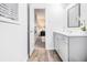 Charming bathroom with wood flooring and a single sink vanity near the bedroom at 6615 Buckhurst Trl, Atlanta, GA 30349