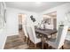 Bright dining area featuring a dark wood table, modern chairs, and stylish decor at 6615 Buckhurst Trl, Atlanta, GA 30349