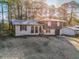 Charming home featuring manicured lawn and a combination brick and siding exterior at 6615 Buckhurst Trl, Atlanta, GA 30349