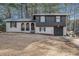 Charming two-story home featuring brick and wood with an attached garage at 6615 Buckhurst Trl, Atlanta, GA 30349