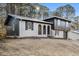 Charming home with brick, wood and black trim nestled on a serene, wooded lot at 6615 Buckhurst Trl, Atlanta, GA 30349