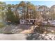Street view of a charming two-story home with a well-manicured front yard and mature trees at 6615 Buckhurst Trl, Atlanta, GA 30349