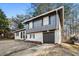 Beautiful home with attached garage with brick and wood features at 6615 Buckhurst Trl, Atlanta, GA 30349