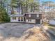 Charming home featuring manicured lawn and a combination brick and siding exterior at 6615 Buckhurst Trl, Atlanta, GA 30349