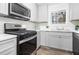 Stylish kitchen with stainless steel appliances, sleek gray cabinetry, and granite countertops at 6615 Buckhurst Trl, Atlanta, GA 30349