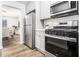 Modern kitchen with stainless steel appliances and hardwood floors overlooks the dining area at 6615 Buckhurst Trl, Atlanta, GA 30349