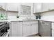 Charming kitchen features stainless steel appliances, white cabinets, and natural light at 6615 Buckhurst Trl, Atlanta, GA 30349