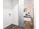 Convenient laundry area with white walls and hardwood floors, located near the living room at 6615 Buckhurst Trl, Atlanta, GA 30349