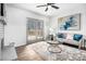 Cozy living room with fireplace, gray sofa, and access to outdoor patio at 6615 Buckhurst Trl, Atlanta, GA 30349