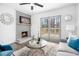 Well-lit living room with fireplace, patio access, and contemporary furniture at 6615 Buckhurst Trl, Atlanta, GA 30349