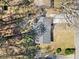 A high-angle of a house with a new roof and lots of trees at 8329 Marlborough Dr, Jonesboro, GA 30238
