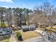 An aerial view of a single-story home with a spacious yard surrounded by lush trees at 8329 Marlborough Dr, Jonesboro, GA 30238