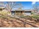 Backyard view of home featuring a new wooden porch with railing, and large trees overhead at 8329 Marlborough Dr, Jonesboro, GA 30238