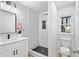 Modern bathroom features stylish black and white tile, updated fixtures, and a rain shower head at 8329 Marlborough Dr, Jonesboro, GA 30238