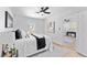 Bright bedroom featuring wood flooring, a ceiling fan, and modern decor with a connecting room at 8329 Marlborough Dr, Jonesboro, GA 30238
