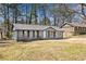 A single-story home with neutral paint and a well-maintained yard with mature landscaping at 8329 Marlborough Dr, Jonesboro, GA 30238